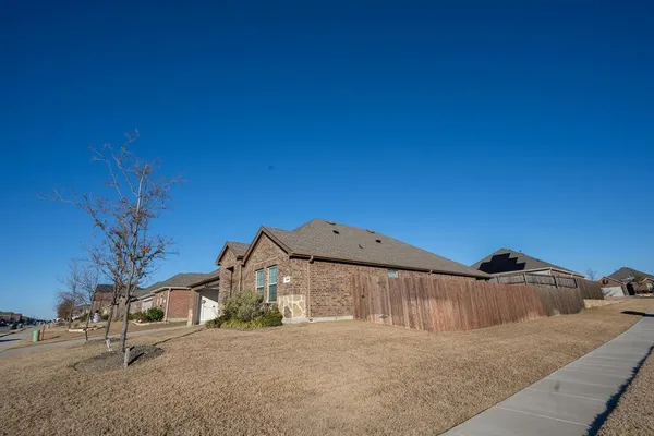 a view of a big house with a yard