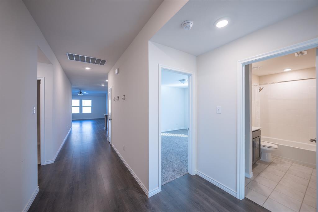 400 Willow View Way Princeton, TX 75407 - Photo 2 of 38 a view of a hallway with wooden floor and a bathroom