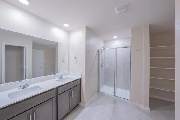 a bathroom with a double vanity sink and a mirror