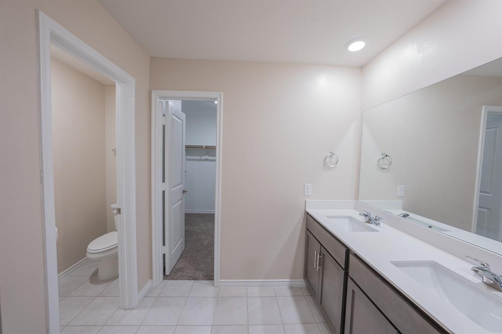 400 Willow View Way Princeton, TX 75407 - Photo 30 of 38 a spacious bathroom with a double vanity sink a toilet and a mirror