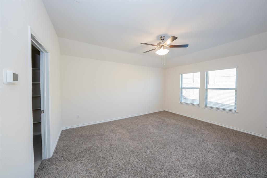 400 Willow View Way Princeton, TX 75407 - Photo 31 of 38 an empty room with a window and a ceiling fan