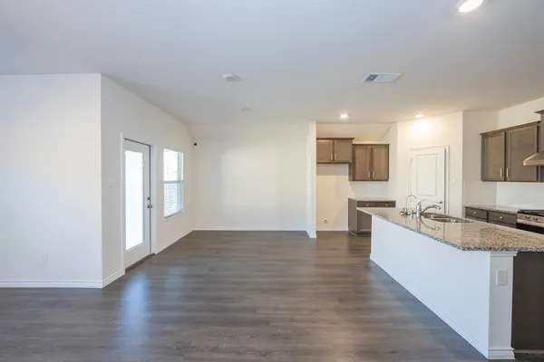 a large kitchen with kitchen island a sink stainless steel appliances and cabinets