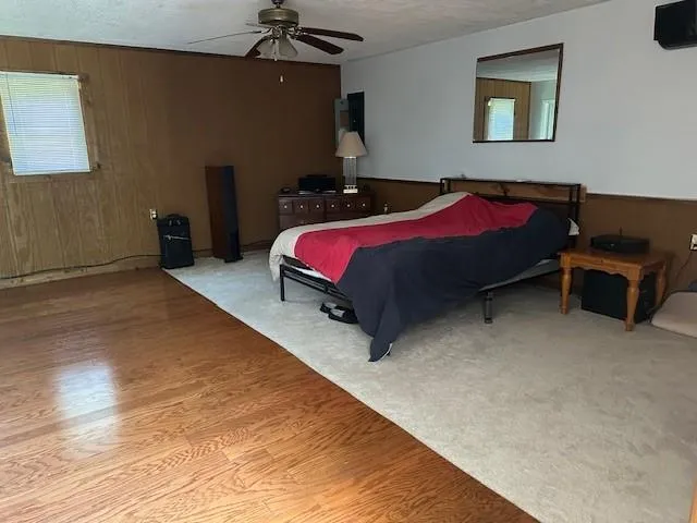 a bedroom with a bed and a lamp on the dresser
