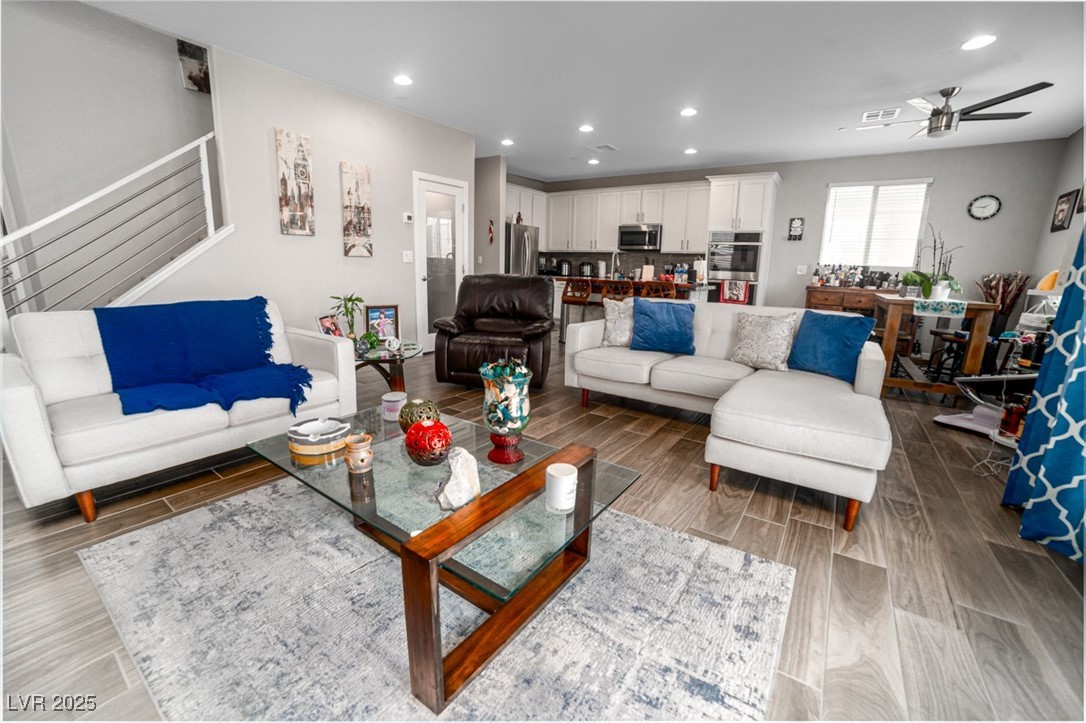 111 Verde Rosa Drive Henderson, NV 89011 - Photo 13 of 51 Living room with wood finish floors, recessed lighting, stairs, and ceiling fan