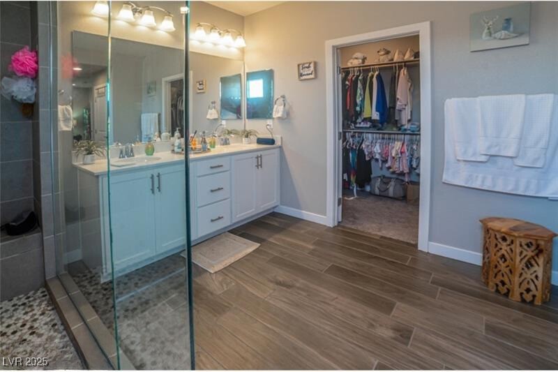 111 Verde Rosa Drive Henderson, NV 89011 - Photo 24 of 51 Full bath with double vanity, wood finish floors, a spacious closet, and a stall shower
