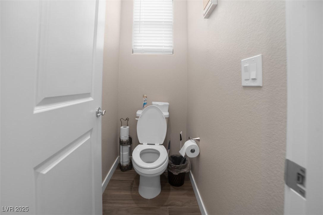 111 Verde Rosa Drive Henderson, NV 89011 - Photo 27 of 51 Bathroom with dark wood-style flooring and a textured wall
