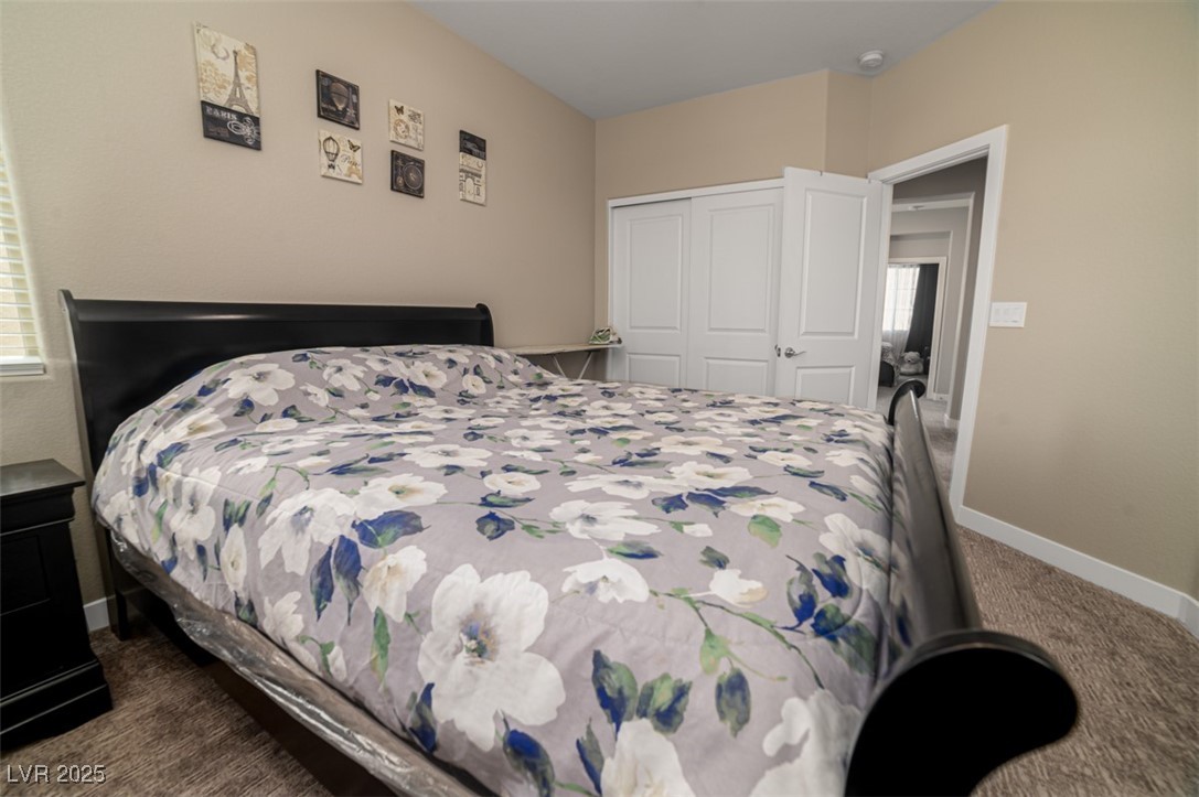 111 Verde Rosa Drive Henderson, NV 89011 - Photo 36 of 51 Bedroom with dark carpet and a closet