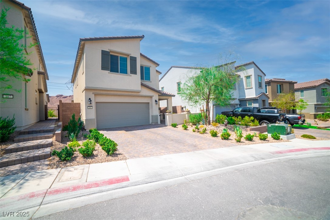 111 Verde Rosa Drive Henderson, NV 89011 - Photo 5 of 51 View of front of house with a garage, stucco siding, decorative driveway, a residential view, and a gate