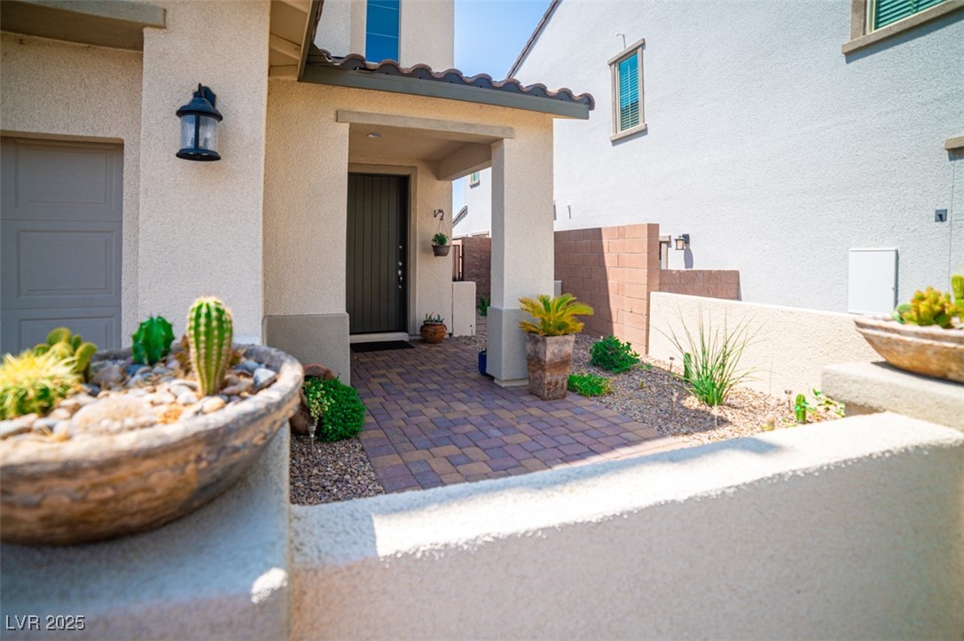 111 Verde Rosa Drive Henderson, NV 89011 - Photo 7 of 51 Doorway to property with stucco siding and a tile roof