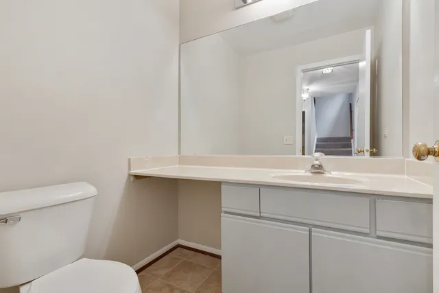 a bathroom with a sink mirror and toilet