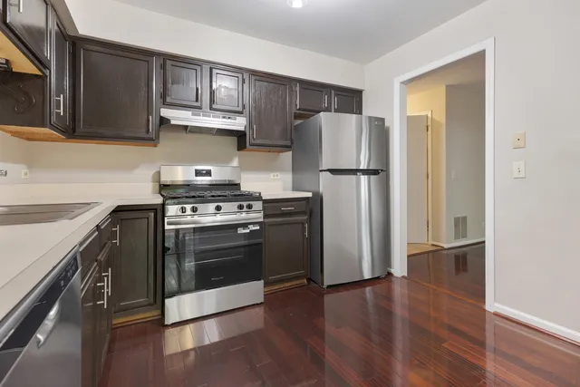a kitchen with a stove a refrigerator and a sink