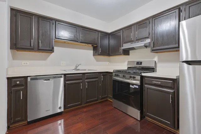 a kitchen with stainless steel appliances granite countertop a stove and a refrigerator