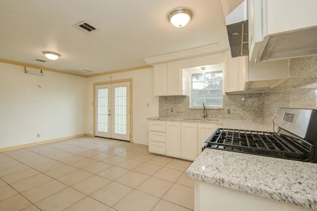 a kitchen with a sink stove and cabinets