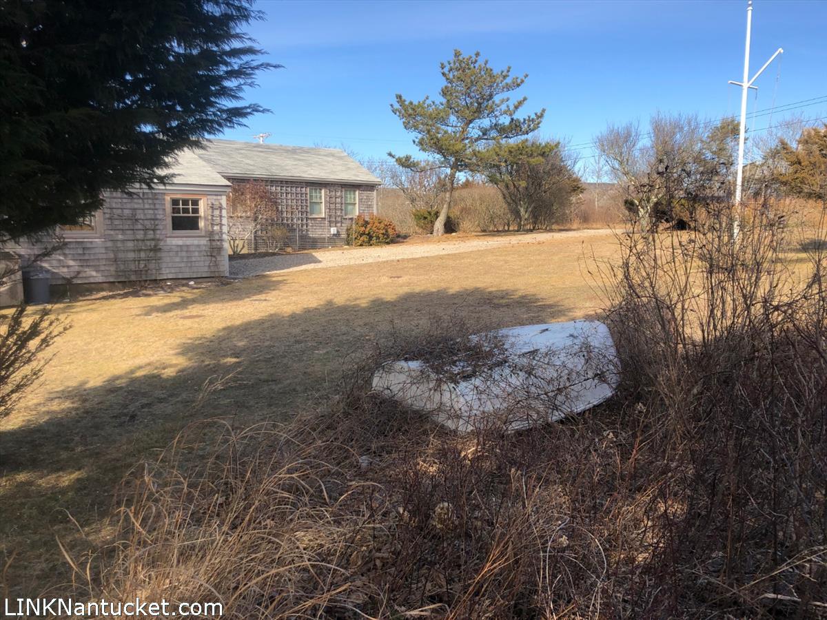 8 M Street Nantucket, MA 02554 - Photo 15 of 20 a view of a yard with a house in the background