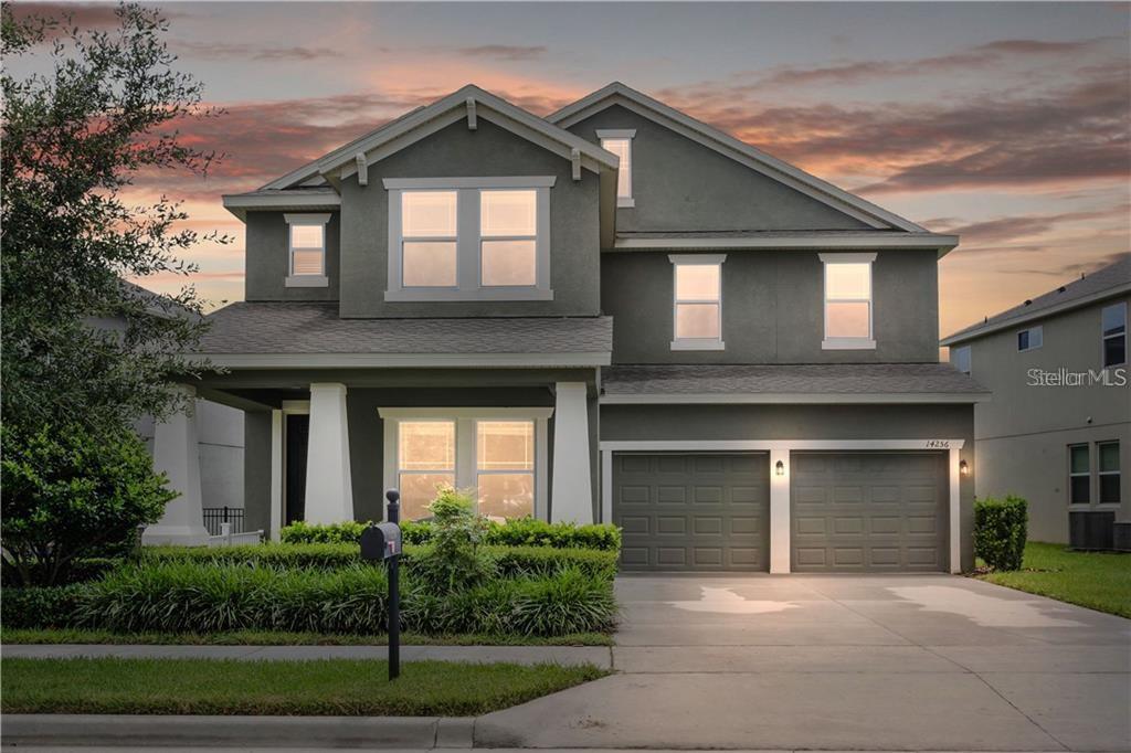14256 Magnolia Ridge Loop Winter Garden, FL 34787 - Photo 1 of 1 a front view of a house with a yard and garage