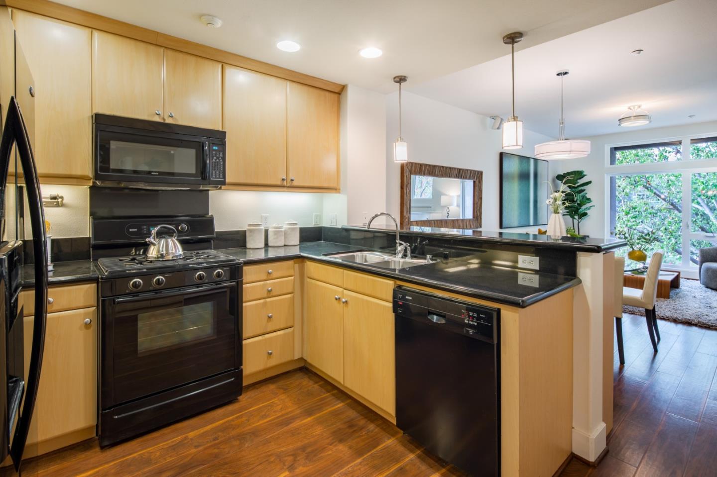 1003 Plover Lane Palo Alto, CA 94303 - Photo 4 of 14 a kitchen with stainless steel appliances granite countertop a sink a stove and a wooden floors