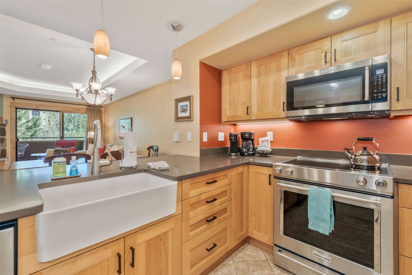 2720 Eagle Ridge Drive, Unit 207 Steamboat Springs, CO 80487 - Photo 12 of 37 a kitchen with stainless steel appliances a stove microwave and sink