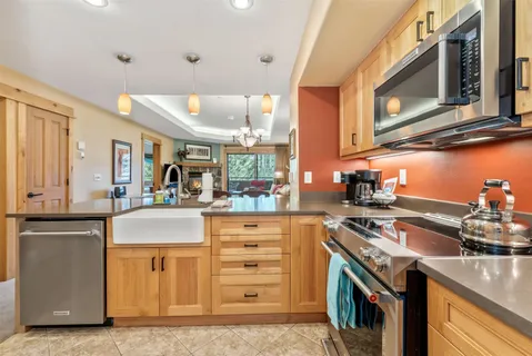 a kitchen with a sink and a stove top oven