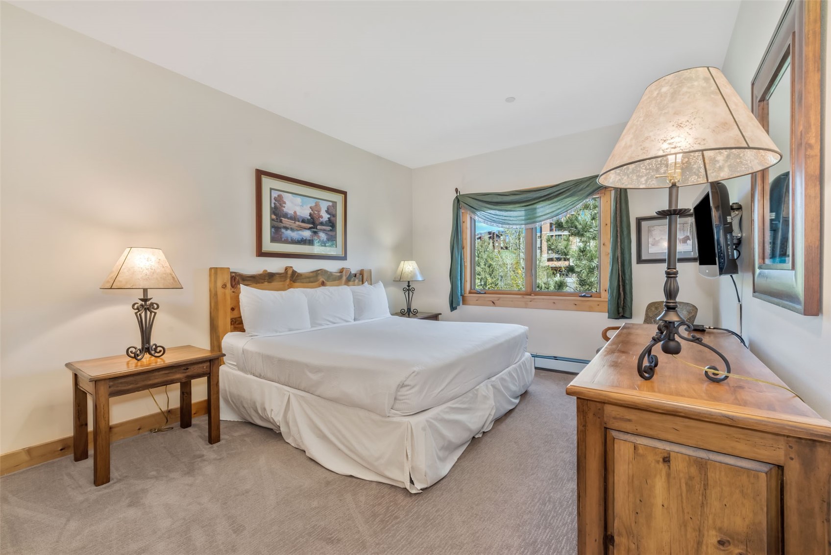 2720 Eagle Ridge Drive, Unit 207 Steamboat Springs, CO 80487 - Photo 16 of 37 a spacious bedroom with a bed a rug and a large window