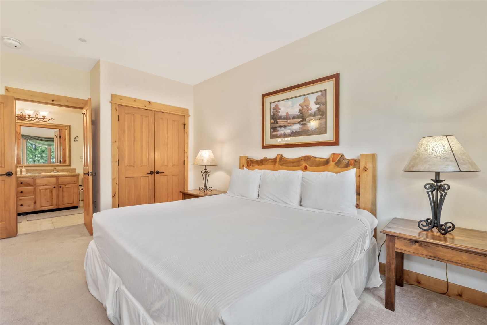 2720 Eagle Ridge Drive, Unit 207 Steamboat Springs, CO 80487 - Photo 18 of 37 a bedroom with a bed and a chandelier