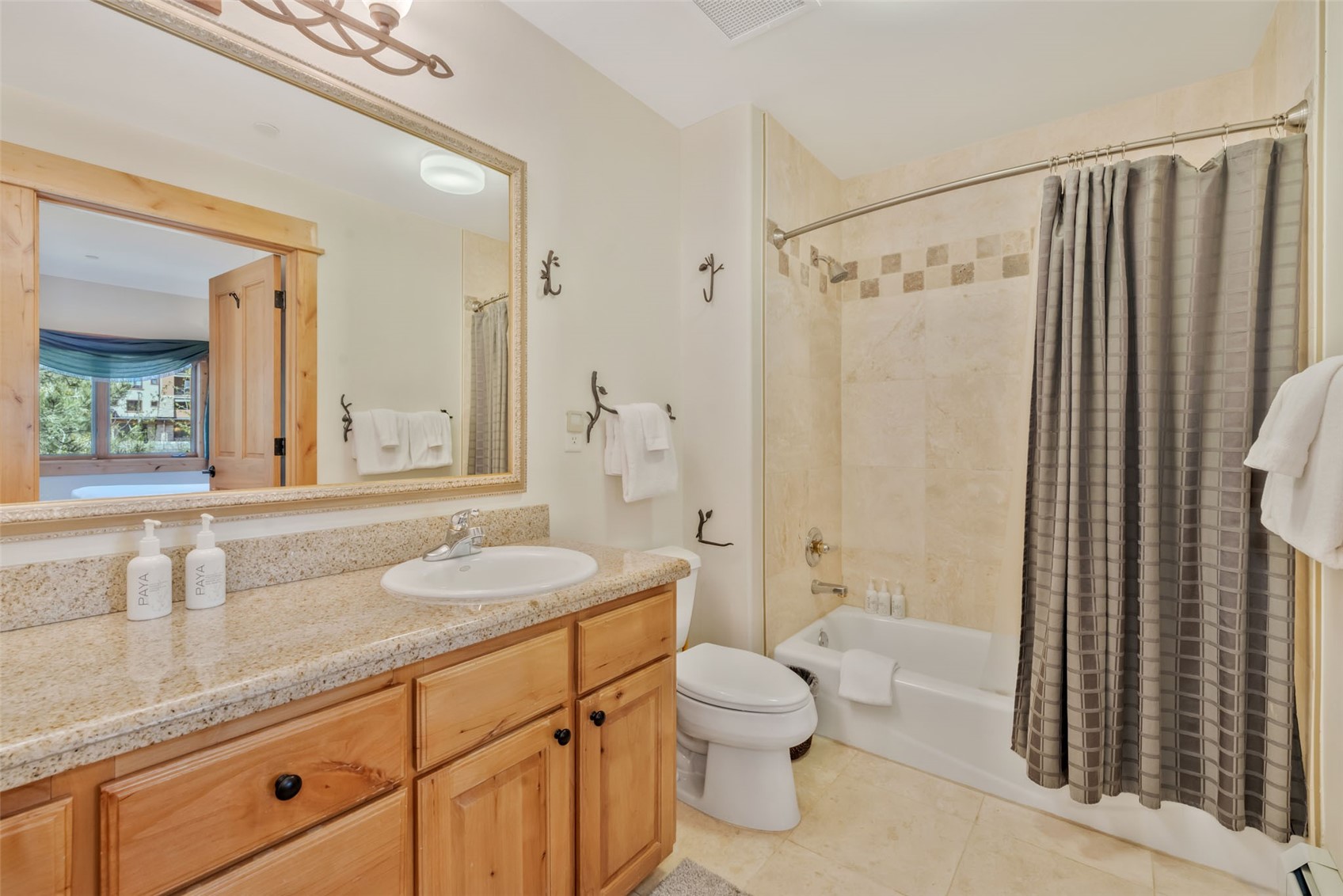 2720 Eagle Ridge Drive, Unit 207 Steamboat Springs, CO 80487 - Photo 19 of 37 a bathroom with a granite countertop sink toilet and shower
