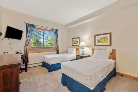 a bedroom with two beds and a window