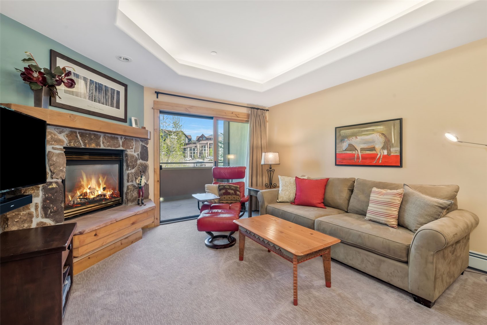 2720 Eagle Ridge Drive, Unit 207 Steamboat Springs, CO 80487 - Photo 2 of 37 a living room with furniture and a fireplace