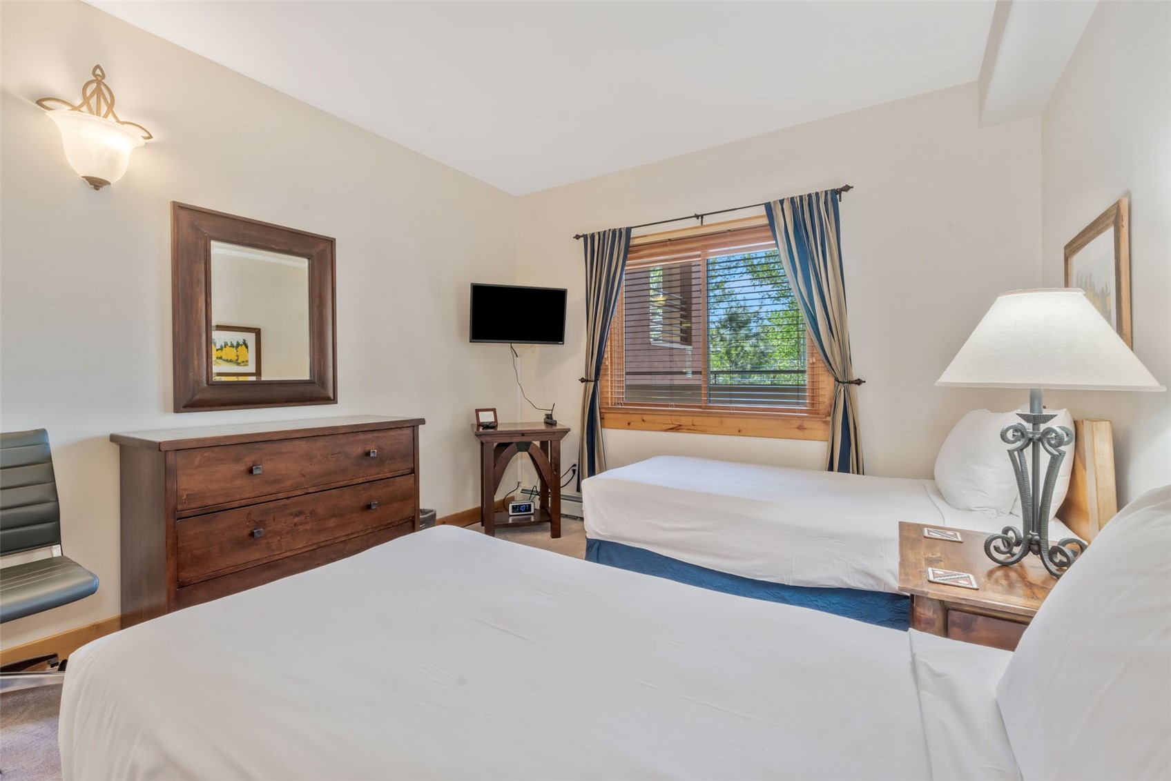 2720 Eagle Ridge Drive, Unit 207 Steamboat Springs, CO 80487 - Photo 21 of 37 a bedroom with a bed and a flat screen tv