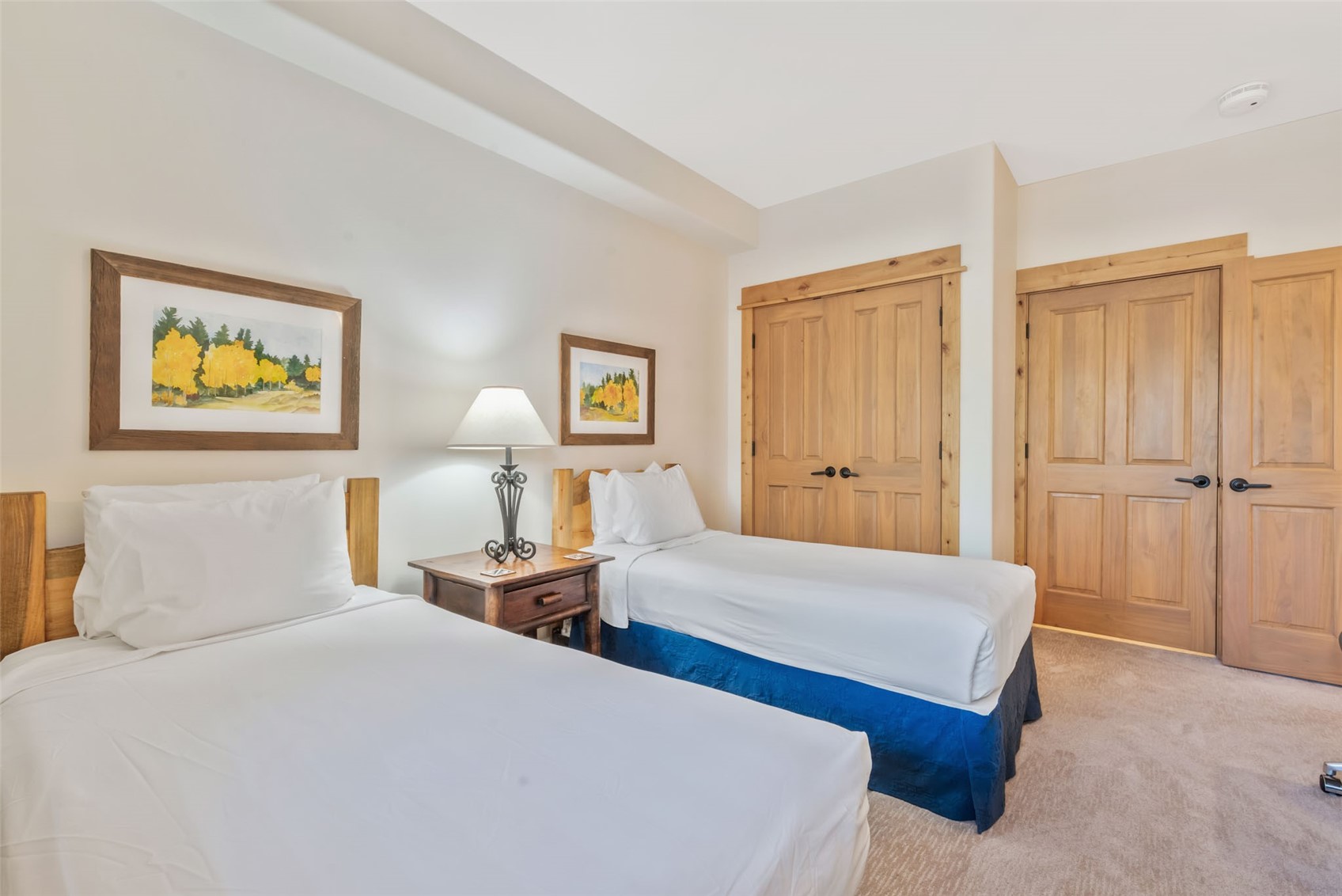 2720 Eagle Ridge Drive, Unit 207 Steamboat Springs, CO 80487 - Photo 22 of 37 a bedroom with two beds and a painting on the wall