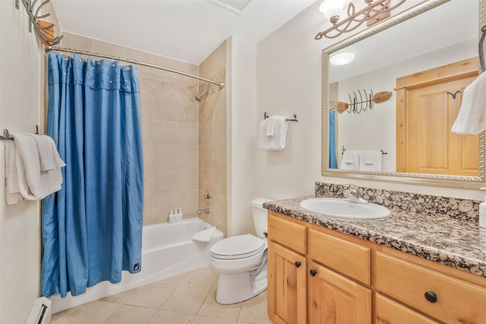 2720 Eagle Ridge Drive, Unit 207 Steamboat Springs, CO 80487 - Photo 23 of 37 a bathroom with a granite countertop sink toilet and shower