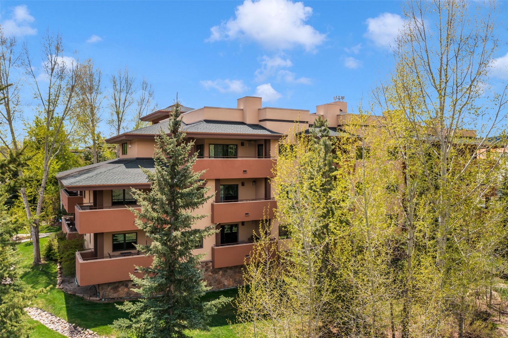 2720 Eagle Ridge Drive, Unit 207 Steamboat Springs, CO 80487 - Photo 29 of 36 a front view of a multi story residential apartment building with yard and parking space