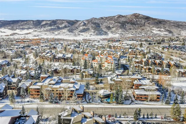 an aerial view of residential building and car parked