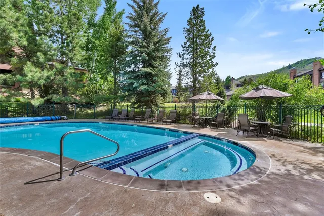 an aerial view of a house with swimming pool and outdoor space