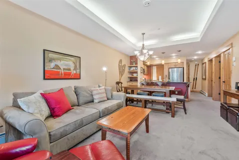 a view of a dining room with furniture and a chandelier