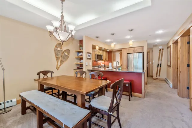 a view of a dining room with furniture and a chandelier