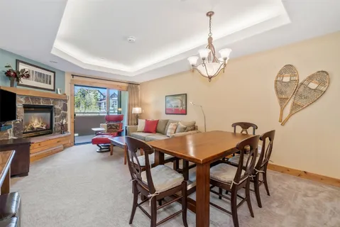 a view of a dining room with furniture a chandelier and wooden floor