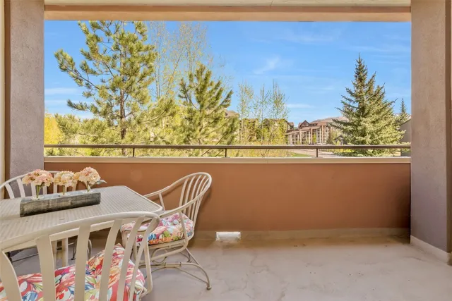 a view of a chairs and table in a balcony