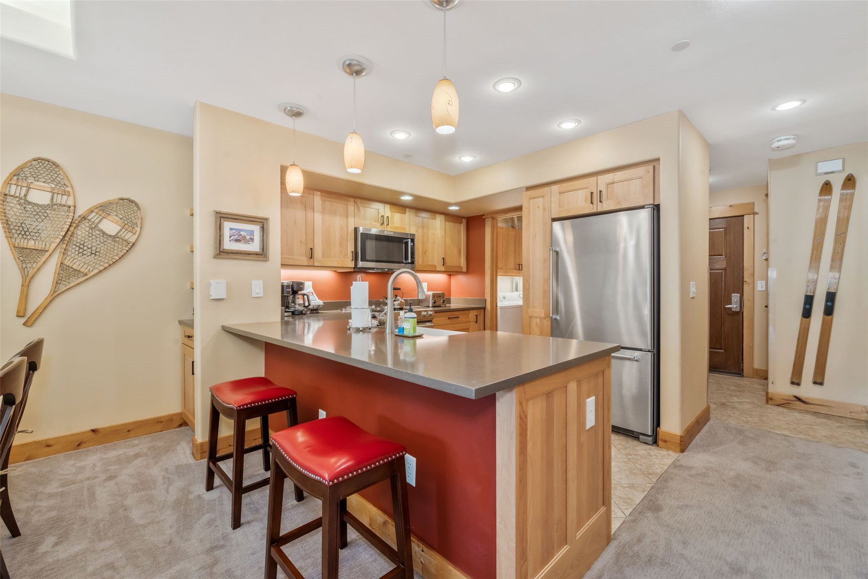 2720 Eagle Ridge Drive, Unit 207 Steamboat Springs, CO 80487 - Photo 10 of 37 a kitchen with stainless steel appliances granite countertop a dining table chairs refrigerator and sink