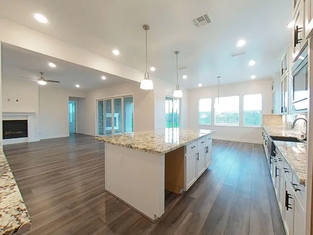 a large kitchen with lots of counter space and stainless steel appliances