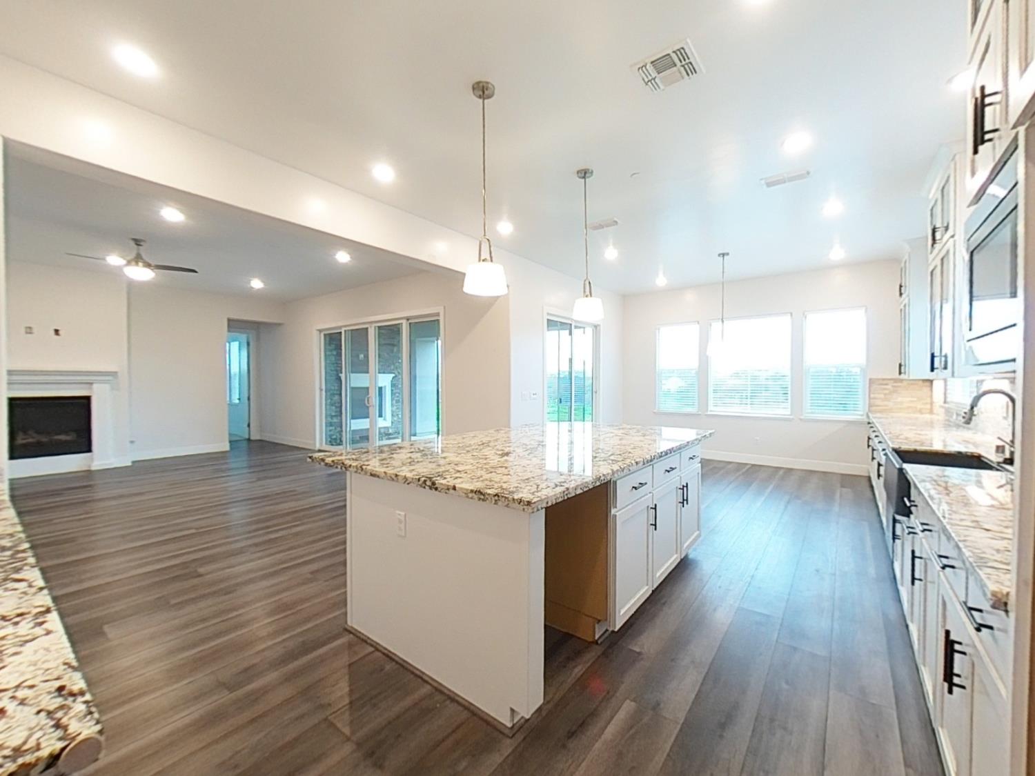 1236 Buck Ridge Rocklin, CA 95765 - Photo 13 of 66 a large kitchen with granite countertop a large counter top a sink stainless steel appliances and cabinets