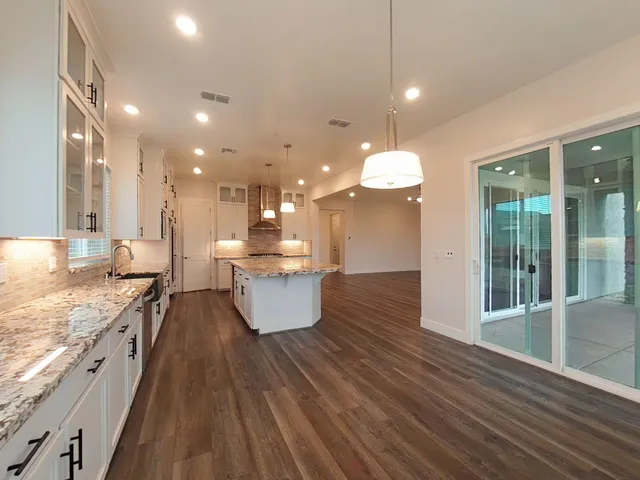 a view of kitchen with kitchen island and stainless steel appliances