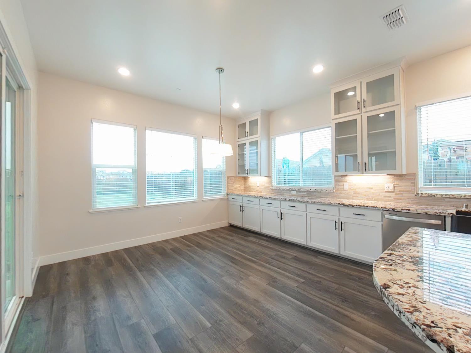 1236 Buck Ridge Rocklin, CA 95765 - Photo 18 of 66 a large kitchen with granite countertop a large window and white appliances