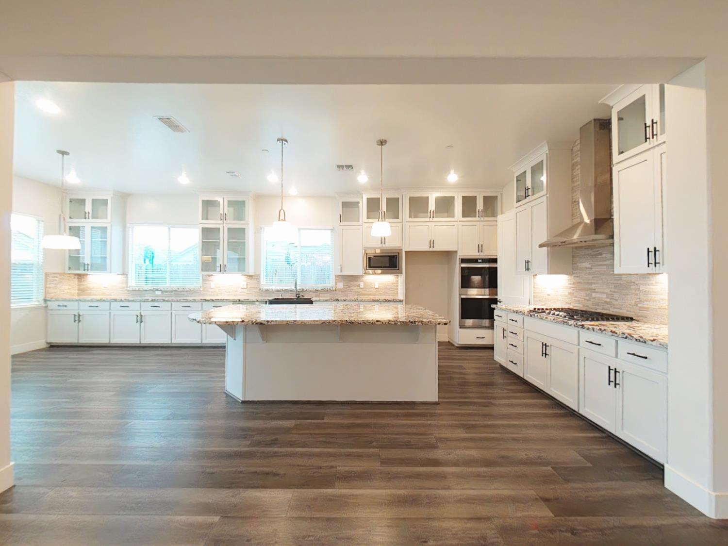 1236 Buck Ridge Rocklin, CA 95765 - Photo 20 of 66 a large kitchen with stainless steel appliances kitchen island granite countertop a large counter top a sink stainless steel appliances and cabinets