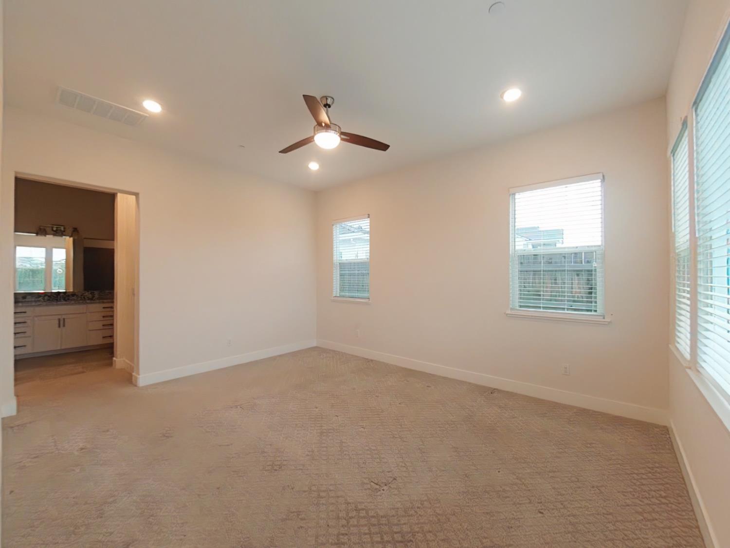 1236 Buck Ridge Rocklin, CA 95765 - Photo 23 of 66 an empty room with windows and fan
