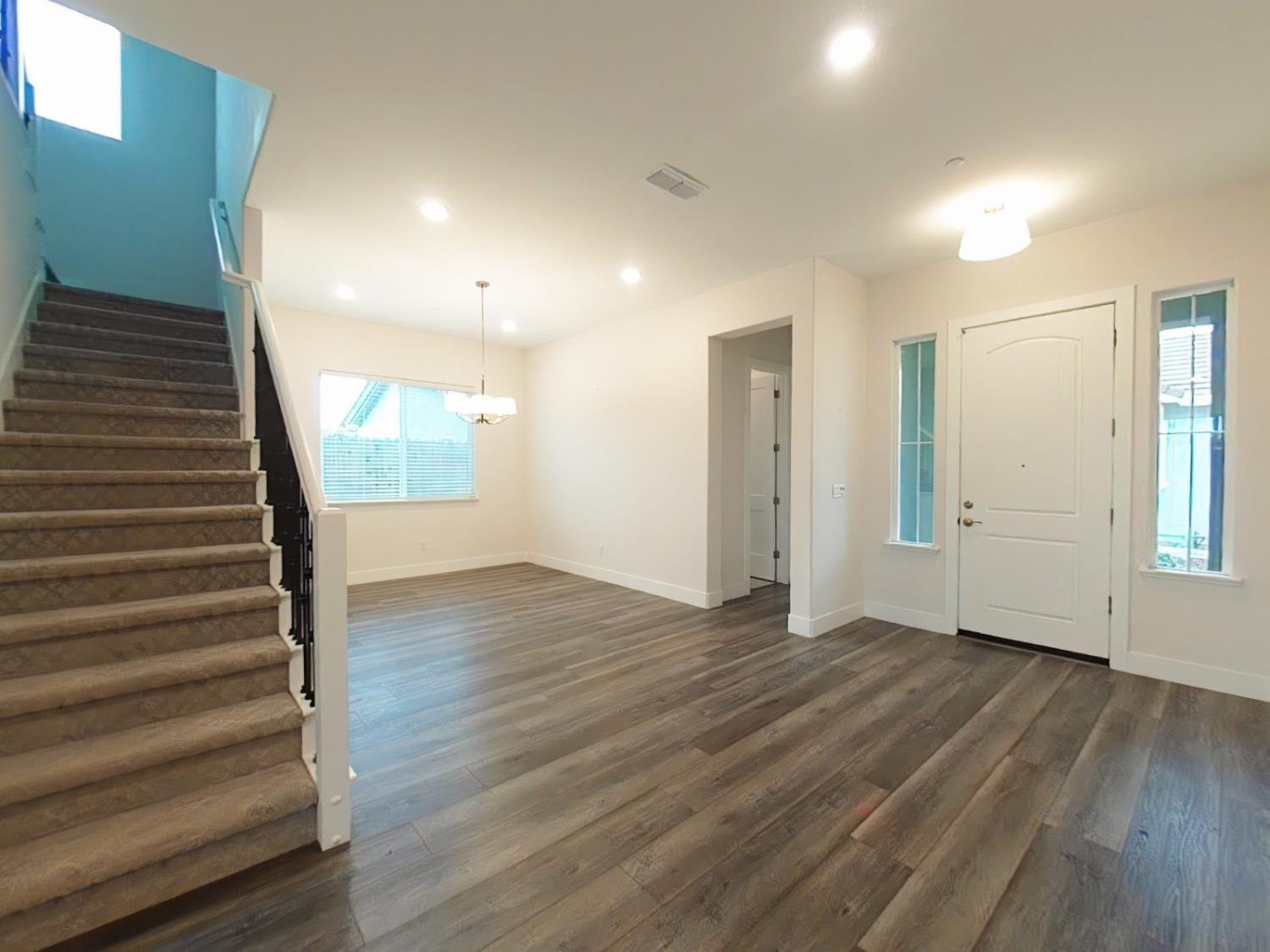 1236 Buck Ridge Rocklin, CA 95765 - Photo 8 of 66 a view of an empty room with wooden floor and windows