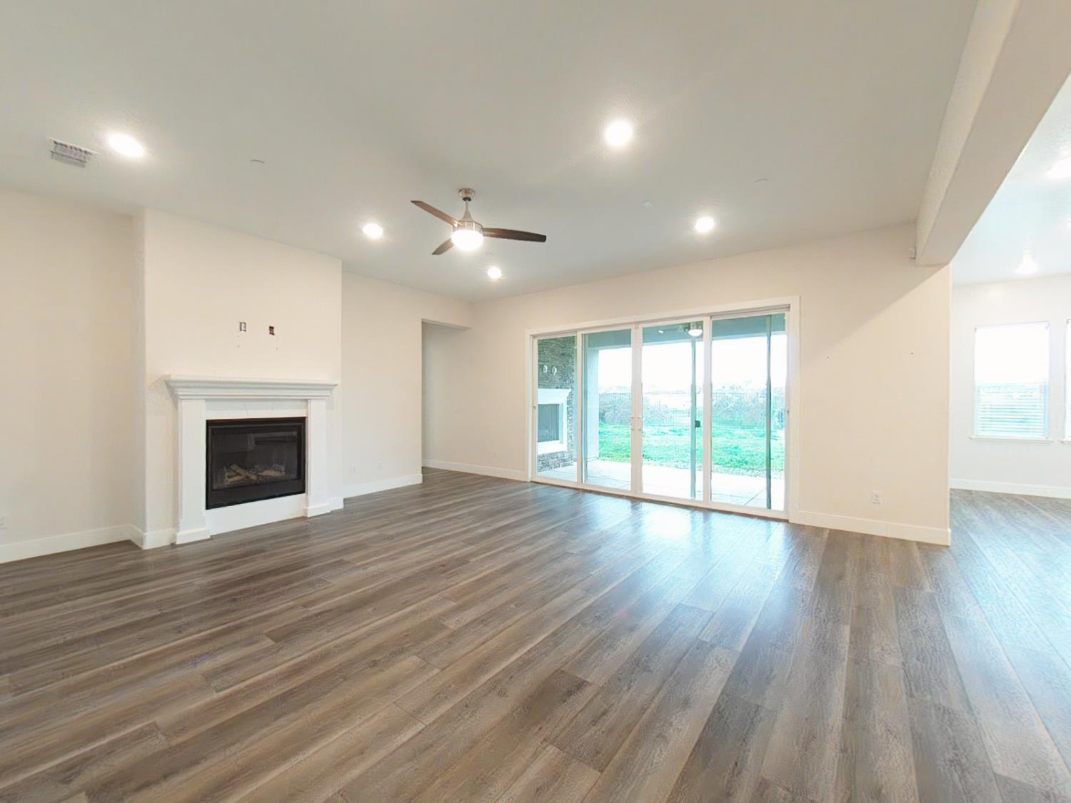 1236 Buck Ridge Rocklin, CA 95765 - Photo 10 of 66 a view of an empty room with wooden floor and a window