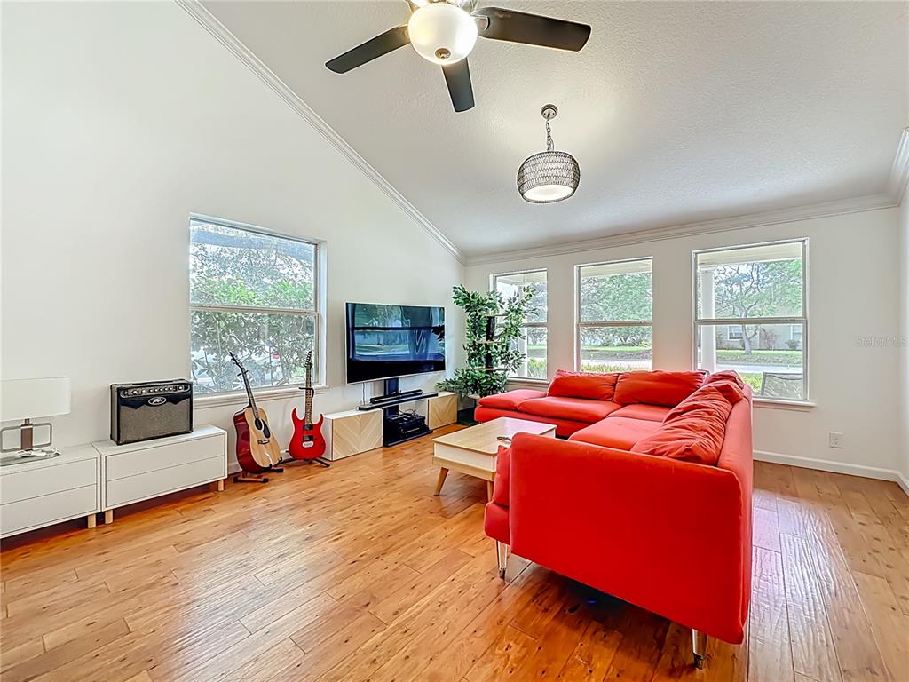 6380 Bahaia Road Fleming Island, FL 32003 - Photo 12 of 77 a living room with furniture and a flat screen tv