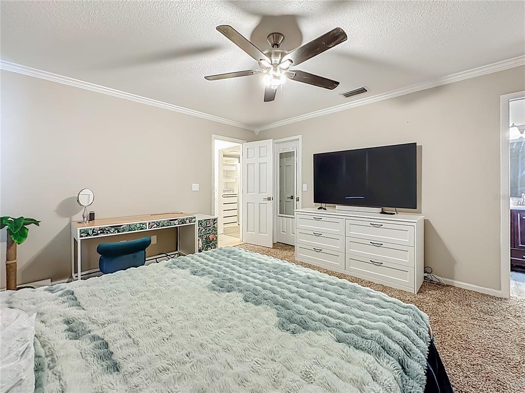 6380 Bahaia Road Fleming Island, FL 32003 - Photo 24 of 77 a bedroom with a bed and a flat screen tv