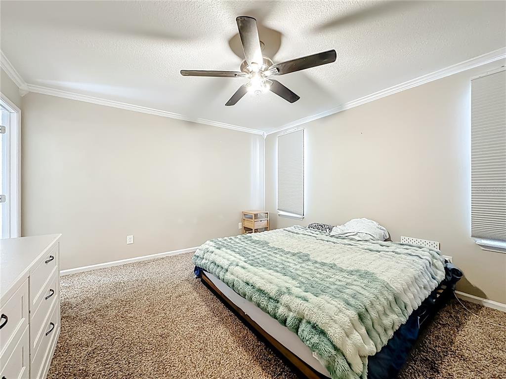 6380 Bahaia Road Fleming Island, FL 32003 - Photo 25 of 77 a bedroom with a bed and cabinets