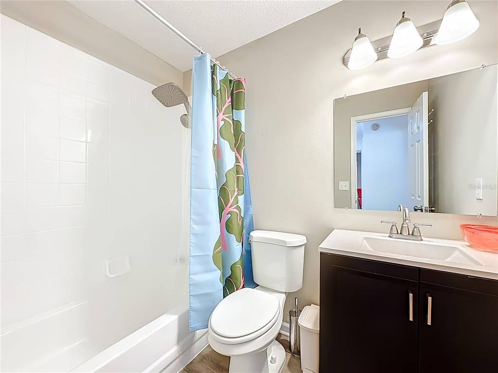 6380 Bahaia Road Fleming Island, FL 32003 - Photo 36 of 77 a bathroom with a sink a toilet a mirror and shower